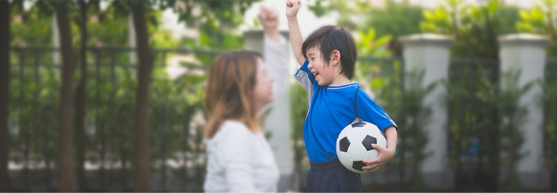 women and a boy holding football